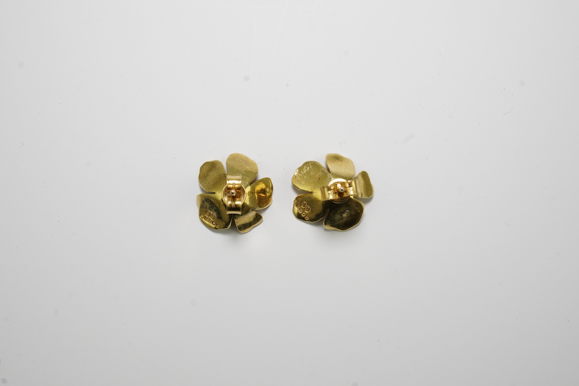 A pair of 1970's 18ct gold and single stone emerald set flower head earrings